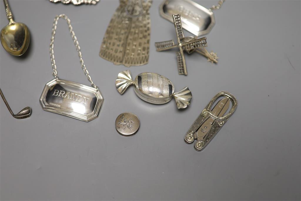 Two white metal novelty pepperettes, three modern silver decanter labels and minor items.